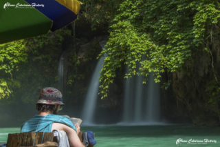 AC-H Kawasan Falls 2nd stage man reading book copyright small_size